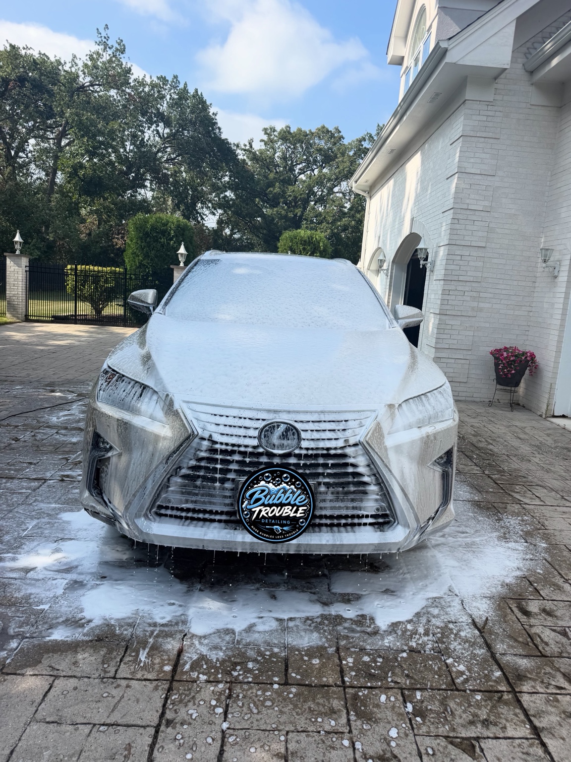 Vehicle covered in wash foam during a detail